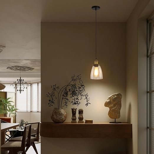 Calia Suspension Cloche en Verre, Douille Laiton – suspension ambrée dans un salon aux tons chauds avec plantes
