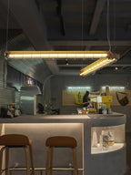 Tubia Suspension Tube en Verre Style Industriel – deux tubes suspendus dans un café aux murs en béton