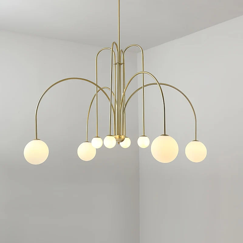 Arcadie Lustre à Bras en Arc – version dorée allumée sur fond beige