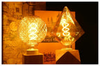 Ampoule Globe à Filament – ampoules losange et globe allumées, ambiance chaude