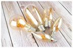 Ampoule Globe à Filament – ampoules bougies à filament posées sur une table en bois clair