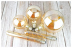 Ampoule Globe à Filament – ampoules globes et tube à filament posées sur une table en bois clair