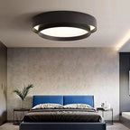 Duo Plafonnier LED Double Cercle – plafonnier noir au-dessus d'un lit à tête de lit bleue