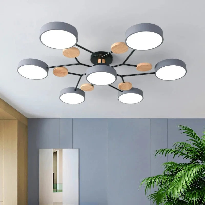 Orbes Plafonnier LED en Métal – disques gris et bois dans une pièce bleu-gris