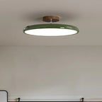 Médaillon Plafonnier LED Rond – disque à bord vert sur un mur gris