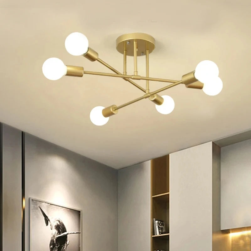 Astra Plafonnier à Bras – version dorée allumée devant un mur beige