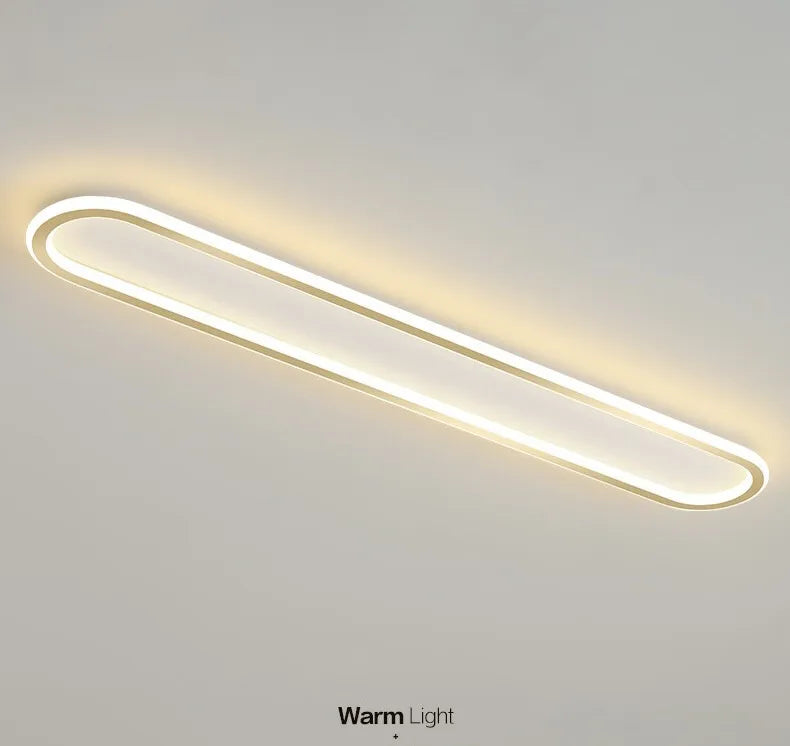 Piste Plafonnier LED Oblong – plafonnier doré et blanc allumé, vue en perspective