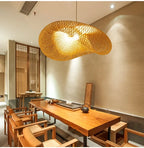Savane Suspension Soucoupe en Rotin Tressé – abat-jour au-dessus d'une longue table en bois