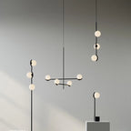 Perla Lustre à Globes en Verre – suspensions verticales et lustre horizontal sur fond gris