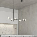 Perla Lustre à Globes en Verre – installé dans une entrée aux murs en béton ciré