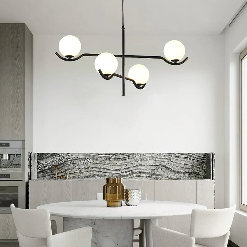 Perla Lustre à Globes en Verre – installé devant un mur en marbre